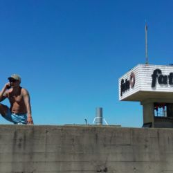 A worker of Argentine tyre company Fate stands atop the roof of the plant during a protest against the announcement of its closure and the dismissal of more than 900 employees, in Virreyes, Buenos Aires province, Argentina, on February 18,