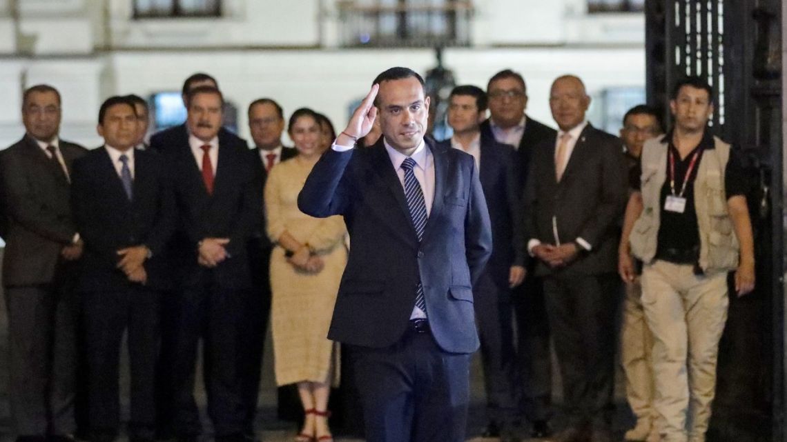Peru's impeached interim President José Jeri gestures with his Cabinet in the background as they walk out of the Government Palace in Lima on February 17, 2026.