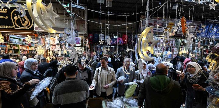 Los sirios compran en un mercado en la Ciudad Vieja de Damasco. Foto de LOUAI BESHARA / AFP