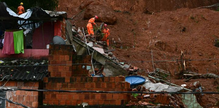 Rescatistas buscan víctimas en un deslizamiento de tierra causado por fuertes lluvias en el barrio Parque Jardim Burnier, Minas Gerais, Brasil. Foto de Pablo PORCIUNCULA / AFP 