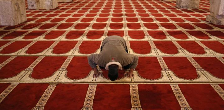 Un hombre palestino reza dentro de la mezquita al-Marawani ubicada en el complejo de la mezquita de Al-Aqsa en Jerusalén. Foto de AHMAD GHARABLI / AFP