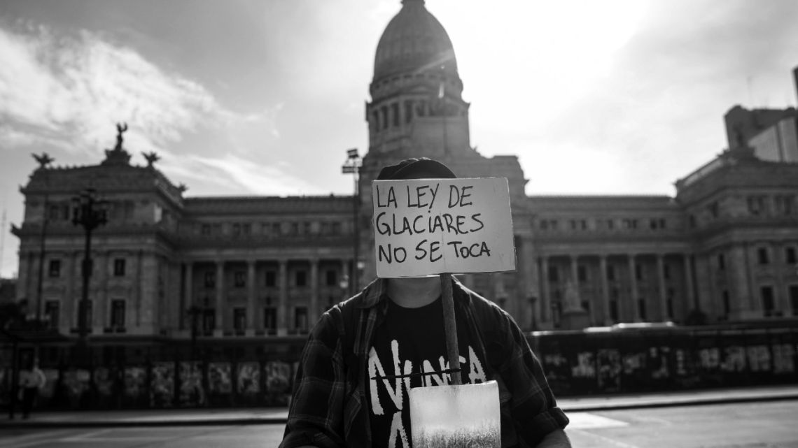 A demonstrator holds a sign that reads in Spanish 'The Glacier Law Is Not To Be Touched' during a protest against glacier law reform outside the National Congress in Buenos Aires, Argentina, on Wednesday, February 25, 2026.