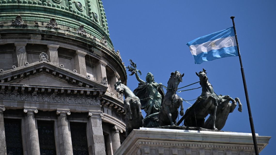 The sculpture La Cuadriga by the Italo-Argentine sculptor Victor de Pol is seen alonside the Argentinian national flag atop the National Congress building in Buenos Aires on February 27, 2026.