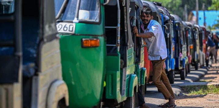 Conductores hacen fila para repostar sus mototaxis en una gasolinera de Biyagama, en las afueras de Colombo. En Sri Lanka, las autoridades aumentaron los precios del GLP en un ocho por ciento, un día después de haber incrementado los precios de los combustibles en un porcentaje similar.