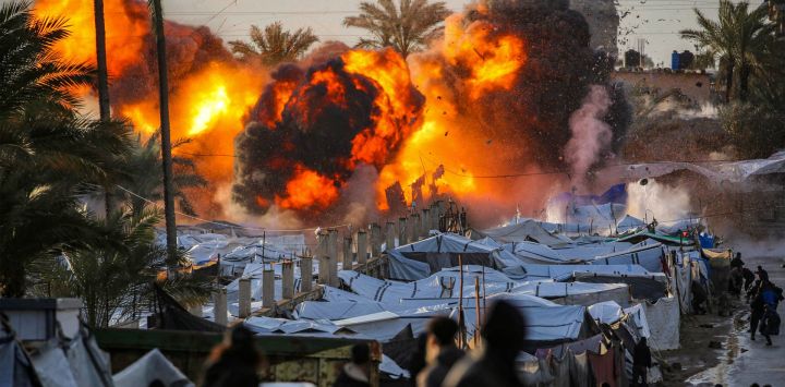 Una bola de fuego estalla tras un ataque israelí cerca de un campamento de tiendas de campaña que alberga a personas desplazadas por la guerra en Deir el-Balah, en el centro de la Franja de Gaza. La violencia ha persistido en Gaza a pesar del alto el fuego que entró en vigor el 10 de octubre, y tanto Israel como Hamás se acusan mutuamente de violaciones.