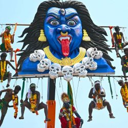 Devotos tamiles suspendidos en el aire desde una grúa perforándose en ganchos de metal para honrar al dios hindú Murugan durante el festival Panguni Uthiram en Mumbai, India. | Foto:Indranil Mukherjee / AFP
