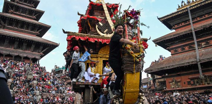 Devotos tiran de una carroza de madera que transporta una estatua de la deidad hindú Bhairav durante el festival "Bisket Jatra", que conmemora el Año Nuevo nepalí, en Bhakapur, en las afueras de Katmandú.