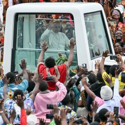 El papa León XIV saluda desde el papamóvil a la multitud congregada a su llegada para oficiar la Santa Misa en el aeropuerto de Bamenda, en Bamenda, en el cuarto día de su viaje apostólico de 11 días a África. | Foto:ALBERTO PIZZOLI / AFP