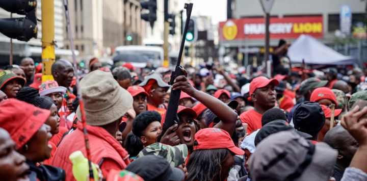 Un simpatizante del líder de los Luchadores por la Libertad Económica (EFF), Julius Malema, sostiene una réplica de arma de fuego mientras se reúne con otros en Johannesburgo, en reacción al fallo de un tribunal sudafricano en KuGompo, antes conocido como East London, que lo condenó a cinco años de prisión por disparar un rifle de asalto en una manifestación ocho años atrás.