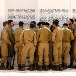 Soldados israelíes se congregan frente a una placa conmemorativa en honor a los soldados israelíes caídos en el Monumento al Cuerpo Blindado, tras una ceremonia para conmemorar el Día del Recuerdo (o Día de la Memoria) en Latrun, entre Jerusalén y Tel Aviv. | Foto:JACK GUEZ / AFP