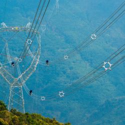 Vista aérea tomada con un dron de técnicos inspeccionando una sección de la línea de transmisión eléctrica del proyecto de interconexión eléctrica China-Laos de 500 kilovoltios (kV), en la prefectura autónoma de la etnia dai de Xishuangbanna, en la provincia de Yunnan, en el suroeste de China. El primer proyecto de interconexión eléctrica transfronteriza de corriente alterna de 500 kV de China entró en operación, ampliando significativamente la capacidad de intercambio de electricidad entre China y Laos. | Foto:Xinhua