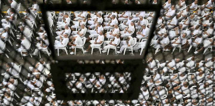 Presuntos miembros de la pandilla Mara Salvatrucha (MS-13) asisten a una audiencia judicial remota por videoconferencia en el Centro de Confinamiento para Terroristas (CECOT) en Tecoluca, El Salvador.