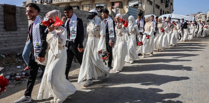 Novios palestinos se reúnen durante una celebración de bodas colectivas organizada por la Fundación Turca de Ayuda Humanitaria (IHH) en la ciudad de Gaza.