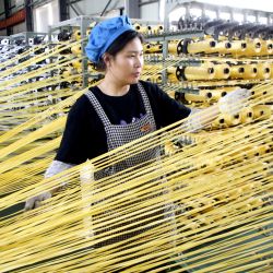 Una trabajadora labora en la línea de producción en el taller de una empresa, en el distrito de Lianyun de la ciudad de Lianyungang, en la provincia de Jiangsu, en el este de China. La economía china experimentó una recuperación constante en los primeros cuatro meses de 2026, con un repunte de los indicadores clave y el impulso de nuevos motores de crecimiento a medida que las políticas macroeconómicas seguían surtiendo efecto. | Foto:Xinhua/Wang Chun