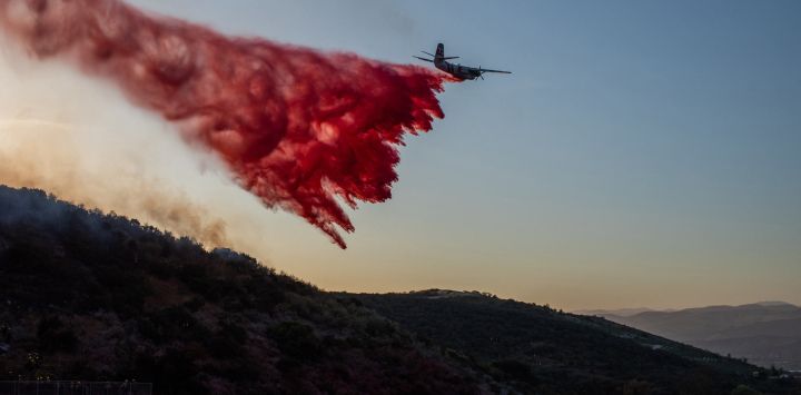 Un avión de Cal Fire arroja retardante de fuego sobre el incendio Sandy mientras arde en las colinas cerca de una zona residencial en Simi Valley, California. Un incendio forestal se desató en los suburbios de Los Ángeles, propagándose rápidamente y obligando a las autoridades a emitir órdenes de evacuación para miles de residentes.