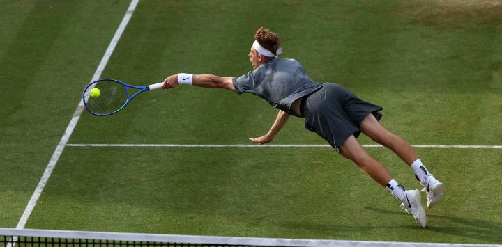 El canadiense Denis Shapovalov se lanza para devolver un golpe durante el desempate del tercer set contra el británico Jack Pinnington Jones en su partido de dieciseisavos de final de individuales masculinos, disputado el primer día del ATP HSBC Championships en el Queen's Club, al oeste de Londres. Shapovalov ganó el partido por 6-4, 4-6 y 7-6.