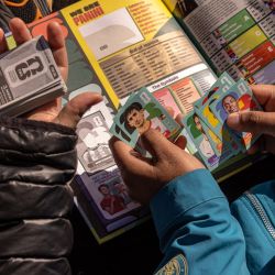 Panini FIFA World Cup stickers are exchanged in Parque Rivadavia. Collectors fill albums with stickers of players representing the 48 teams competing in the World Cup.