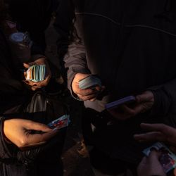Panini FIFA World Cup stickers are exchanged in Parque Rivadavia. Collectors fill albums with stickers of players representing the 48 teams competing in the World Cup.