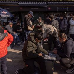 Panini FIFA World Cup stickers are exchanged in Parque Rivadavia. Collectors fill albums with stickers of players representing the 48 teams competing in the World Cup.