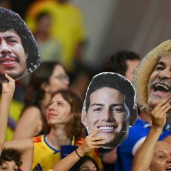 Aficionados colombianos muestran figuras de cartón que representan al exfutbolista colombiano René Higuita, al centrocampista James Rodríguez, al exfutbolista Carlos Valderrama y al delantero Luis Díaz durante el partido de fútbol del Grupo K del Mundial 2026 entre Uzbekistán y Colombia en el Estadio de la Ciudad de México. | Foto:YURI CORTEZ / AFP
