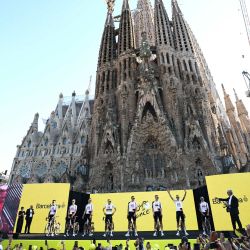 Ciclistas del equipo UAE Team Emirates - XRG asisten a la ceremonia de presentación del equipo previa a la 113.ª edición del Tour de Francia, con la Basílica de la Sagrada Familia al fondo, en Barcelona, noroeste de España. | Foto:ANNE-CHRISTINE POUJOULAT / AFP