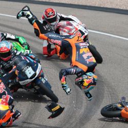 El piloto argentino Valentín Perrone (C, volando por los aires) y el piloto español Marcos Uriarte (D, cayendo en la pista), del equipo Red Bull KTM Tech3, sufren un accidente durante la carrera de Moto3 en el circuito de Sachsenring, en Hohenstein-Ernstthal, cerca de Chemnitz, al este de Alemania, antes del Gran Premio de Alemania de MotoGP. | Foto:RONNY HARTMANN / AFP