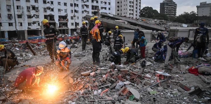 Voluntarios y rescatistas buscan cuerpos entre los escombros de edificios dañados por los terremotos del 24 de junio en Tanaguarena, estado de La Guaira, Venezuela. Los dos terremotos que azotaron Venezuela el mes pasado causaron la muerte de más de 5.000 personas, según informaron las autoridades, que anunciaron la obtención de cientos de millones de dólares del Fondo Monetario Internacional (FMI) para la reconstrucción.