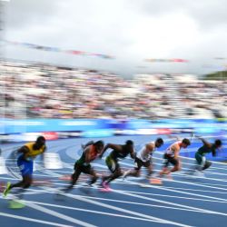 Los atletas compiten en la séptima serie de los 100 metros masculinos durante la prueba de atletismo en el estadio Scotstoun de Glasgow, en el cuarto día de los Juegos de la Commonwealth en Glasgow, Escocia. | Foto:Andy Buchanan / AFP