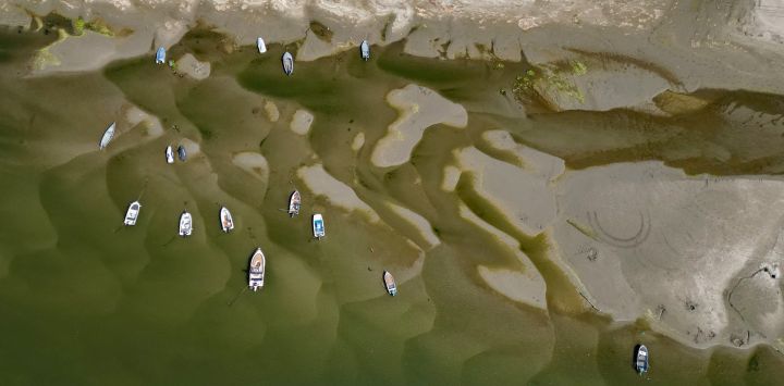 La vista aérea muestra embarcaciones en las aguas poco profundas del río Danubio en Corabia, al sur de Rumania. La prolongada sequía y el calor extremo en toda Europa han provocado que el nivel del agua del Danubio alcance mínimos históricos para la época del año, registrando su caudal más bajo en los últimos 30 años.