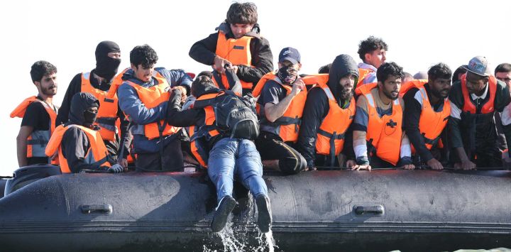 Migrantes a bordo de una embarcación de traficantes intentan cruzar el Canal de la Mancha frente a la playa de Gravelines, en el norte de Francia.