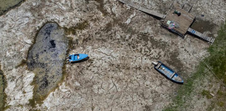 Una fotografía aérea muestra barcos varados en el lecho seco del río Danubio frente al puente Calafat-Vidin, que conecta Bulgaria y Rumania cerca del pueblo de Antimovo, en el sureste de Bulgaria. En la ciudad rumana de Corabia, a orillas del Danubio, algunos barcos se encuentran encallados en aguas poco profundas llenas de algas en el puerto turístico, que permanece desierto ya que los barcos no pueden atracar debido a los bancos de arena.