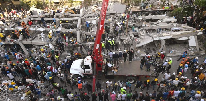 Rescatistas y voluntarios buscan sobrevivientes entre los escombros de un edificio derrumbado tras el terremoto en Cali, Colombia.