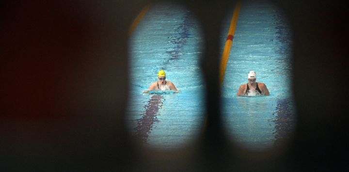 La australiana Ella Ramsay (izquierda) y la sudafricana Aimee Canny compiten en las eliminatorias de los 200 metros braza femeninos en el Centro Internacional de Natación Tollcross en Glasgow, en el sexto día de los Juegos de la Commonwealth en Glasgow, Escocia.