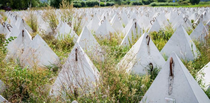 En la zona de Piedruja, durante la visita del presidente de Letonia, quien inspeccionará la frontera entre Letonia y Bielorrusia, se pueden observar los llamados dientes de dragón, obstáculos antitanque piramidales de hormigón armado utilizados para impedir el paso de vehículos militares.