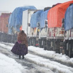 Una indígena boliviana camina en una carretera bajo una intensa nevada, en la salida de la ciudad de La Paz, Bolivia. Bolivia marcó una inusual ola de frío que transformó carreteras, ciudades y comunidades en cinco de sus nueve departamentos en escenarios de nieve, hielo y temperaturas bajo cero, con cientos de vehículos varados, pasajeros en las carreteras y restricciones al tránsito en algunas de las principales rutas que conectan el occidente con el centro y el oriente del país. | Foto:Xinhua/Javier Mamani