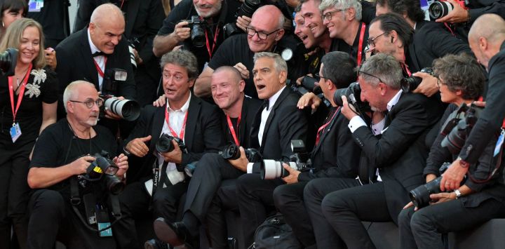 El actor y cineasta estadounidense George Clooney bromea con los fotógrafos durante la alfombra roja previa a la proyección de "Hink" y la ceremonia de inauguración del 83.º Festival Internacional de Cine de Venecia, en el Lido de Venecia.