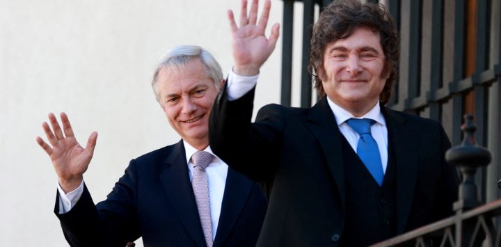 El presidente de Chile, José Antonio Kast y el presidente de Argentina, Javier Milei, saludan desde un balcón del Palacio de La Moneda en Santiago.