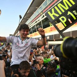 El piloto italiano de Mercedes, Kimi Antonelli, sostiene su trofeo mientras celebra con sus compañeros de equipo tras ganar el Gran Premio de Italia de Fórmula 1 en el circuito Autodromo Nazionale Monza en Monza, al norte de Italia. | Foto:MARCO BERTORELLO / AFP