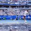 Fotogaleria El argentino Francisco Cerundolo saca contra el belga Alexander Blockx, reflejado en el espejo de un equipo de televisión, durante su partido de octavos de final individuales masculinos