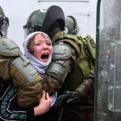 Carabineros de Chile detienen a una mujer durante una marcha en memoria de las víctimas de la dictadura de Augusto Pinochet (1973-1990), con motivo del 53.º aniversario del golpe de Estado que llevó a Pinochet al poder, en Santiago. | Foto:Javier Torres / AFP