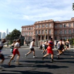 Corredores compiten en el Maratón Internacional de Buenos Aires a su paso frente a la Casa Rosada, sede del gobierno argentino, en Buenos Aires. | Foto:LUIS ROBAYO / AFP