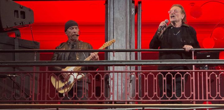The Edge (izquierda) y Bono (derecha), de la banda de rock irlandesa U2, actúan en el balcón del Bewley's Oriental Cafe, en el centro de Dublín, con motivo del 50.º aniversario de su formación en 1976.
