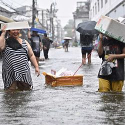 Residentes se desplazan entre aguas de inundación y fuertes lluvias en el distrito de Bang Kapi, Bangkok. Ocho personas han fallecido a causa de las inundaciones en Tailandia, aunque ninguna en la capital, Bangkok —que declaró el estado de desastre tras las intensas precipitaciones—, según informó el gobierno. | Foto:LILLIAN SUWANRUMPHA / AFP