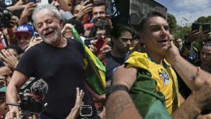 04_10_2026_lula_flavio_bolsonaro_afp_g