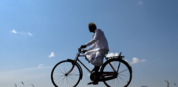 Un hombre recorre en bicicleta la presa del embalse de Ibbankatuwa en Dambulla, Sri Lanka.