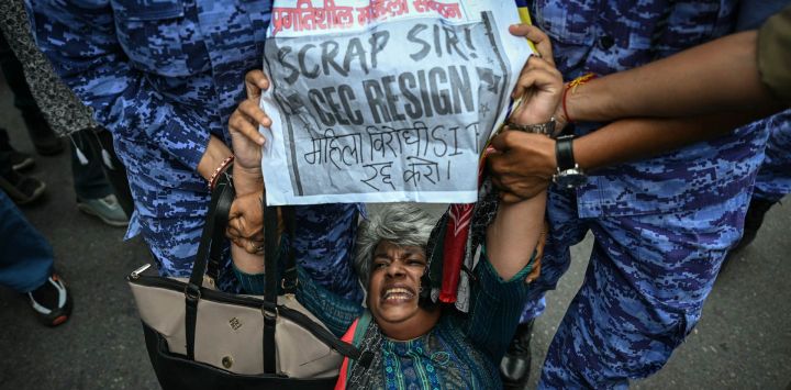 Personal de seguridad detiene a un activista durante una protesta para exigir la dimisión del Comisionado Jefe de Elecciones de la India, Gyanesh Kumar, debido a presuntas irregularidades en el censo electoral relacionadas con la "revisión intensiva especial" (SIR), cerca de Jantar Mantar, en Nueva Delhi.