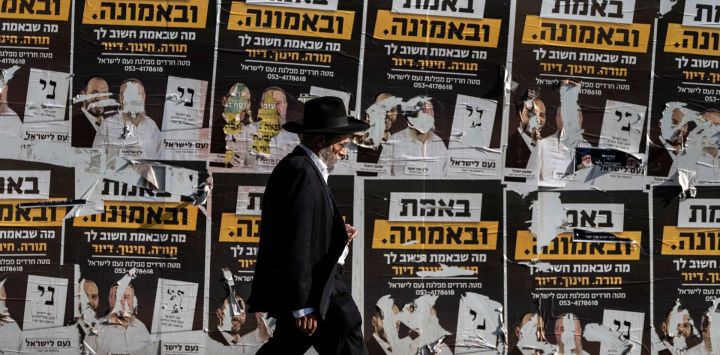 Un hombre judío ultraortodoxo pasa junto a carteles electorales rasgados —entre otros carteles— en un muro a lo largo de una calle en Jerusalén, de cara a las elecciones legislativas de Israel. Israel acudirá a las urnas el 27 de octubre en sus primeras elecciones desde el ataque liderado por Hamás el 7 de octubre de 2023, en lo que se considera un referéndum sobre el primer ministro.