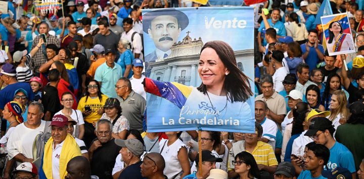 Manifestantes sostienen fotografías de la líder opositora venezolana y ganadora del Premio Nobel de la Paz, María Corina Machado, durante una concentración para exigir elecciones en Caracas, Venezuela.
