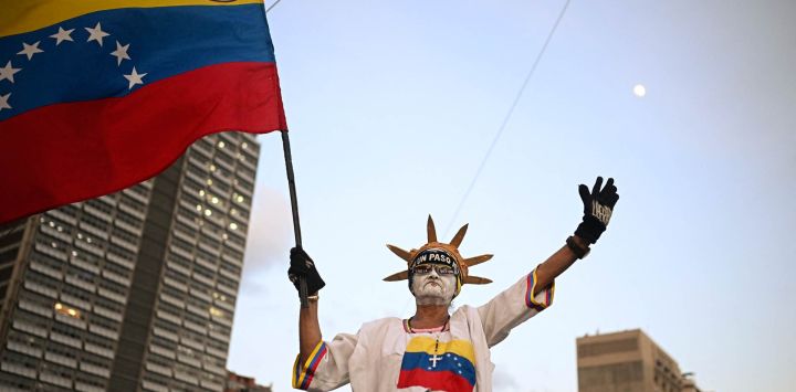 Un partidario de la líder opositora venezolana y ganadora del Premio Nobel de la Paz, María Corina Machado, ondea una bandera de Venezuela durante una manifestación para exigir elecciones en Caracas, Venezuela.