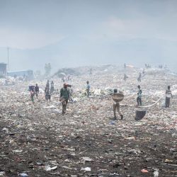 Recicladores de residuos y otros trabajadores realizan sus labores diarias en el vertedero de Mubone, en el distrito de Buterere, Buyumbura. En el vertedero de Mubone —el principal depósito de desechos que da servicio a Buyumbura, la capital comercial de Burundi—, cientos de mujeres pasan sus jornadas buscando fragmentos de carbón y materiales reciclables para venderlos en los mercados locales. Muchas de ellas son el único sustento de sus hogares y ganan alrededor de 2000 francos burundeses (aproximadamente 0,70 dólares) al día para mantener a sus familias, en un contexto donde la grave inflación y la escasez de combustible a nivel nacional han disparado la demanda de fuentes de energía doméstica más económicas. | Foto:Herve Shabani / AFP